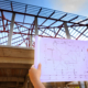 Hands Holding Home Extension Plans